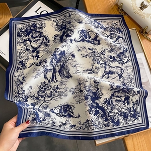 Detail of silk scarf featuring blue Toile de Jouy forest animals and tree patterns