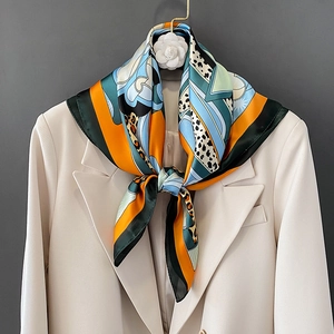 Elegant silk scarf with leopard print and geometric panels in orange and green