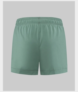 Detail of green sports shorts showing the elastic waistband and quick-dry breathable fabric
