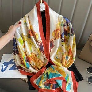Artistic oil painting silk scarf with yellow and blue patterns styled on a black sweater