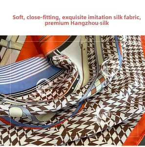 Detail of silk-like scarf featuring orange geometric rope patterns and smooth texture
