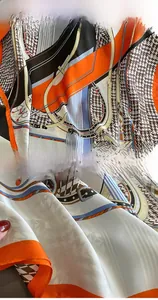 Close-up of houndstooth silk scarf with vintage equestrian belt pattern and stitched edges