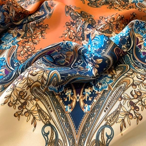 Macro detail of silky printed scarf with vintage paisley floral patterns and satin sheen