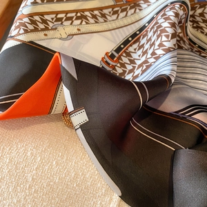 Close-up of houndstooth silk scarf with elegant geometric patterns and satin sheen