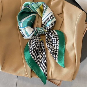 Fashionable houndstooth silk scarf with geometric patterns tied on a blazer lapel