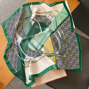 Classic houndstooth silk scarf with green geometric horse harness design and satin finish