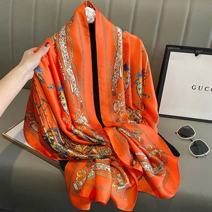 Elegant orange silk square scarf with vintage golden chain and horse bit patterns