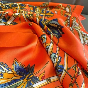 Detailed view of luxury silk scarf with horse bridles and floral equestrian patterns