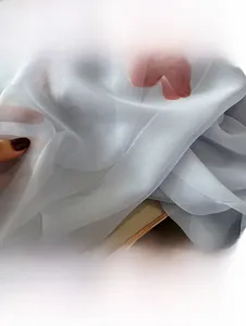 Detail of light blue floral chiffon scarf showing soft texture and semi-transparent fabric