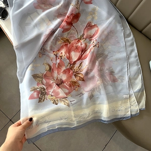 Light blue floral chiffon scarf with pink magnolia print and elegant script lettering
