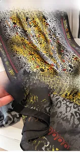 Détail d'un foulard en soie à imprimé léopard avec coutures fines et motifs cœurs