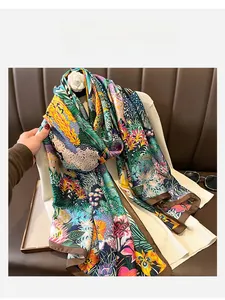 Close-up of tropical floral print silk scarf with fine dark brown hem edges