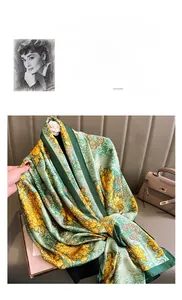 Detail of silk-feel scarf featuring vintage green and gold floral chrysanthemum patterns