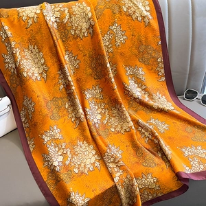 Elegant orange silk scarf with traditional floral patterns and autumn warmth decor