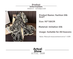 Detail of 90x180cm paisley silk scarf showing elegant black and white pattern and texture