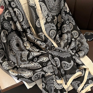 Classic black and white paisley silk-like scarf with a smooth finish and fine edges