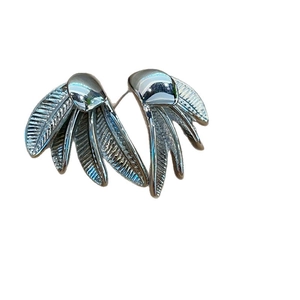Dramatic banana leaf feather earrings in 18k gold plating with detailed texture