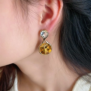 925 silver needle drop earrings with amber faceted crystals and gold finish on model