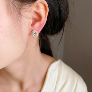 Elegant gold-plated round halo earrings with sparkling cubic zirconia on model