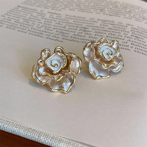 Elegant white enamel camellia flower earrings with gold petals and crystal accents