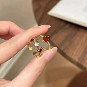 Close-up of gold-plated rings with red heart-shaped stones and shimmering crystals