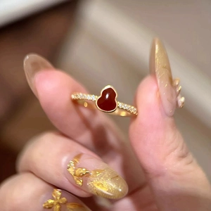 Macro shot of 18K gold open ring with red gourd inlay and sparkling zircon pavé detail