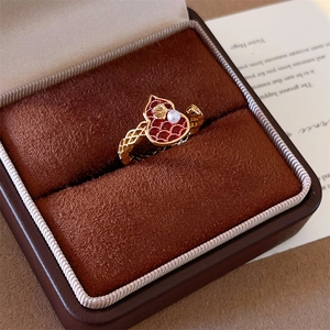 Vintage red enamel gourd open ring with pearl detail on a gold braided band