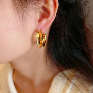 Modern gold plated C-shape hoop earring with a polished chunky irregular wide surface