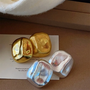 Textured geometric cube earrings in gold and silver with a matte hammered finish