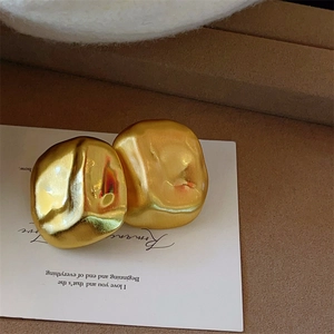 Elegant gold irregular geometric stud earrings with brushed metallic texture and matte finish
