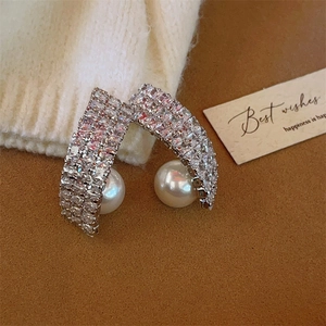 Elegant silver C-shaped pearl drop earrings with sparkling cubic zirconia pavé setting