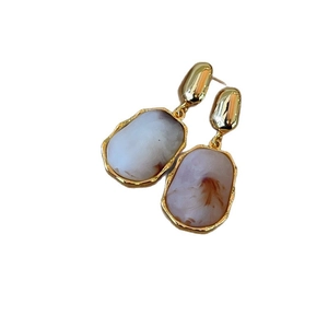 Elegant irregular oval resin drop earrings in ivory white with luxury gold-tone metal frame