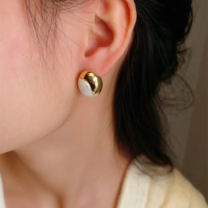 Minimalist gold and silver two-tone oval stud earrings with mixed matte and polished finish