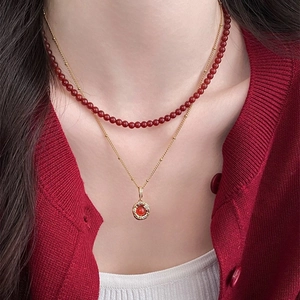 Double-layered tiger eye stone necklace with gold chain and red beaded pendant for women
