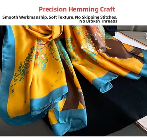 Detail view of precision hemming on a silk scarf with floral patterns and smooth edges