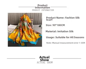 Detail of silk-like scarf with yellow tree print draped over a chic handbag