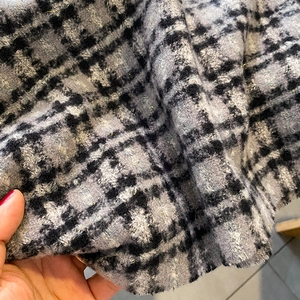 Gros plan du tissu d'écharpe en cachemire à carreaux épais avec fils d'or tissés