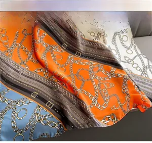 Close-up of silk-like scarf with chain print showing high-quality stitching and smooth edges