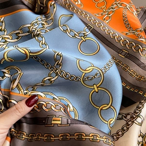 Silk-like fashion scarf with vintage gold chain prints in blue and orange contrast