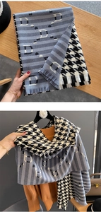Detailed shot of houndstooth scarf with blue-grey stripes, letter D and fringe edges