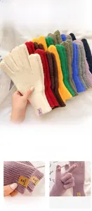 Detail view of colorful knitted touchscreen gloves with premium leather label patch