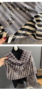 Detail of fringe edges and houndstooth pattern on grey and brown woven scarf