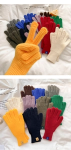 Detail of knitted winter gloves showcasing thick rib knit cuffs and diverse color options