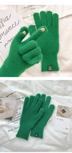 Detail showing forest green knit gloves with waffle texture and fingerless design