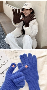 Detail of knitted winter gloves showing finger openings for smartphone screen use