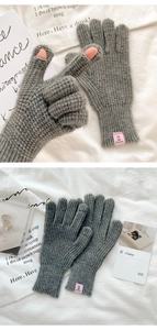 Macro detail of gray knitted touch screen gloves with thumb and index finger openings