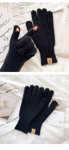 Macro shot of black knitted gloves featuring a leather patch and textured stitching details