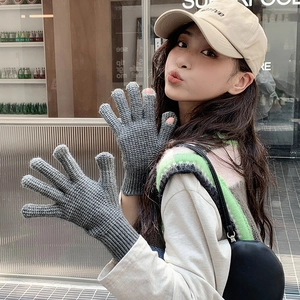 Grey knitted gloves with touchscreen finger opening and ribbed cuffs for winter warmth