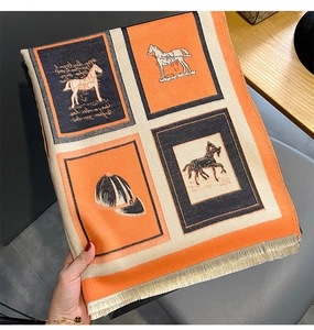 Detailed view of horse motif pashmina scarf with elegant beige fringe and orange blocks
