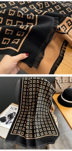 Detailed view of two-tone knit scarf with G-letter jacquard and soft fringed edges